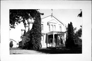 207-209 W HOWARD ST, a Dutch Colonial Revival house, built in Portage, Wisconsin in 1901.
