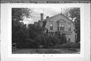 207-209 W HOWARD ST, a Dutch Colonial Revival house, built in Portage, Wisconsin in 1901.
