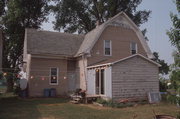 9390 CEMETERY RD, a Dutch Colonial Revival house, built in Brussels, Wisconsin in 1921.