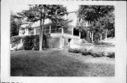 9163 COTTAGE ROW, a Dutch Colonial Revival house, built in Gibraltar, Wisconsin in 1920.