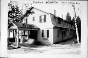9163 COTTAGE ROW, a Dutch Colonial Revival house, built in Gibraltar, Wisconsin in 1920.