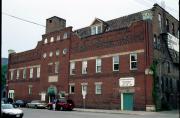 317-319 S BARSTOW ST / 306 MAIN ST, a Romanesque Revival retail building, built in Eau Claire, Wisconsin in 1899.