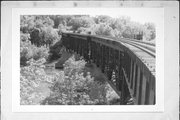 EAU CLAIRE RIVER, S OF FORMER UNIROYAL PLANT, a NA (unknown or not a building) deck truss bridge, built in Eau Claire, Wisconsin in 1910.