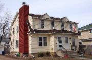 209 - 211 CLEVELAND ST, a Dutch Colonial Revival duplex/two-flat, built in Menasha, Wisconsin in 1933.