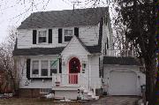 212 ELM ST, a Dutch Colonial Revival house, built in Menasha, Wisconsin in 1931.