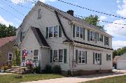 634 RACINE ST, a Dutch Colonial Revival duplex/two-flat, built in Menasha, Wisconsin in 1937.