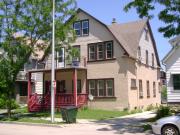 2028-30 S 84TH ST, a Dutch Colonial Revival house, built in West Allis, Wisconsin in 1909.