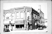 147-149-151 W HURON ST, a Queen Anne large retail building, built in Berlin, Wisconsin in 1895.