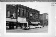 147-149-151 W HURON ST, a Queen Anne large retail building, built in Berlin, Wisconsin in 1895.