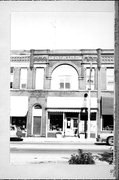 147-149-151 W HURON ST, a Queen Anne large retail building, built in Berlin, Wisconsin in 1895.