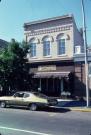 180-184 E MAIN ST, a Romanesque Revival retail building, built in Stoughton, Wisconsin in 1876.