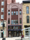 27 N PINCKNEY ST, a Romanesque Revival retail building, built in Madison, Wisconsin in 1897.