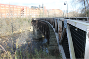 EAU CLAIRE RIVER, S OF FORMER UNIROYAL PLANT, a NA (unknown or not a building) bridge, built in Eau Claire, Wisconsin in 1910.