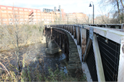 EAU CLAIRE RIVER, S OF FORMER UNIROYAL PLANT, a NA (unknown or not a building) deck truss bridge, built in Eau Claire, Wisconsin in 1910.