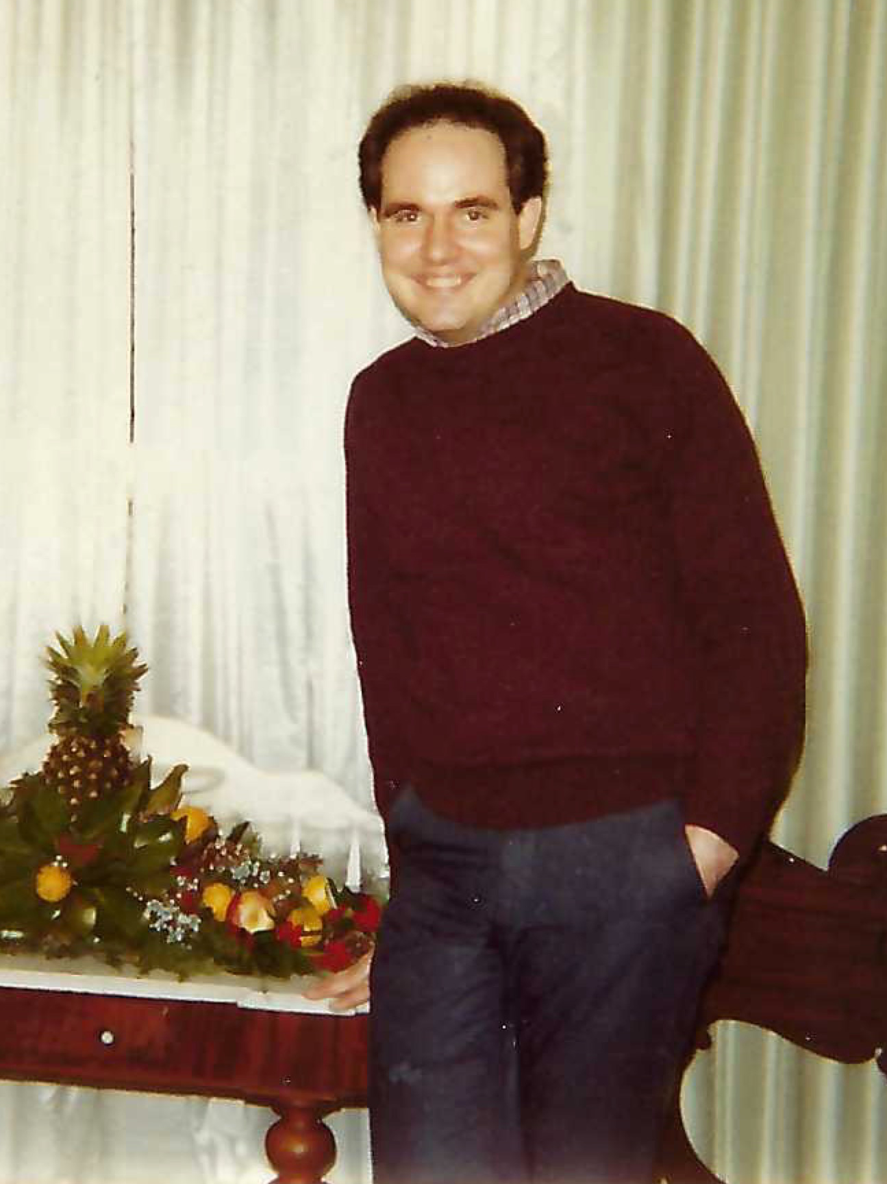 Photo Credit: Bill Carter David Carter informal portrait, smiling, medium short hair, a burdundy knit sweater with a plaid collar from a button up poking out.