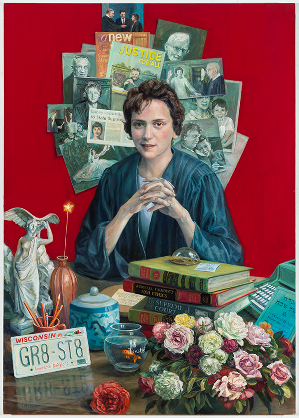 WHI ID #3701 Shirley Abrahamson's portrait with her seated at a desk in her judge robes. Behind her are a variety of newspapers, pictures, and posters plastered to the wall in a circle/halo effect. In front of her on the desk there are a variety of items: Lady Justice, a vase, a sparkler, a stack of legal books, a jar, goldfish in a bowl, a arrangement of roses and other flowers, the Torah, a typewriter, pencils, and a Wisconsin license plate.