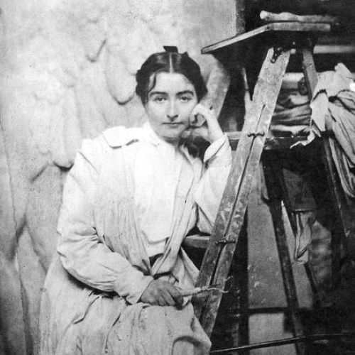 Helen Farnsworth Mears sitting on a ladder and resting her head against her hand.