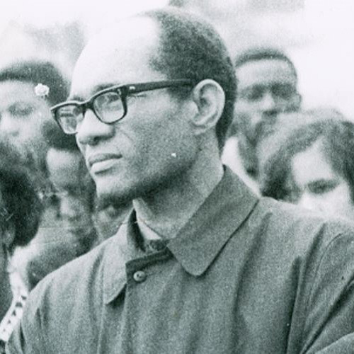 Lloyd Barbee in a somber crowd at a memorial gathering for Dr. Martin Luther King, Jr. Looking off to the left his expression serious.