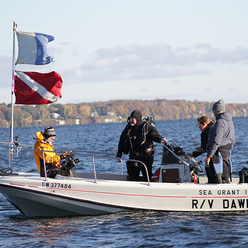 The flags wave from the bow of the boat as the divers prepare.