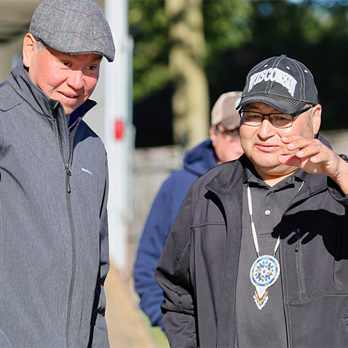 Bill Quackenbush and Marlon WhiteEagle discuss the canoe.