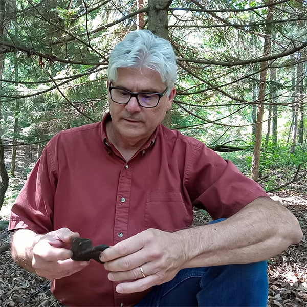 Jim examines something will standing in the woods