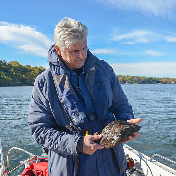 Jim Skibo, examines a a piece of ancient wood