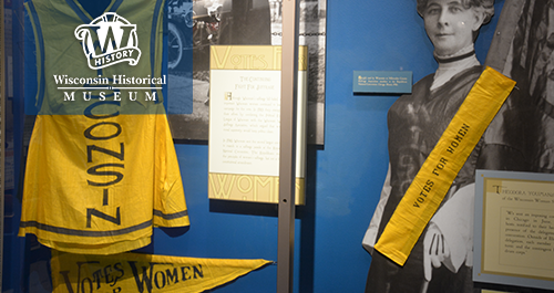 Wisconsin Historical Museum. A museum display of photographs and other suffrage paraphinalia in the iconic purple and gold of the movement in the United States in the early 20th century.