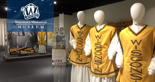 Wisconsin Historical Museum. Three figures wear suffrage vests outside the Women's suffrage exhibit at the museum.