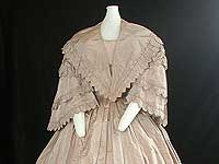 Full view of front of dress with coat. Tan and off-white striped silk wedding dress. Gift of Elizabeth Marshall. <br />Wisconsin Historical Museum object # 1945.974.