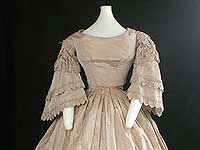 Full view of front of dress without coat. Tan and off-white striped silk wedding dress. Gift of Elizabeth Marshall. <br />Wisconsin Historical Museum object # 1945.974.