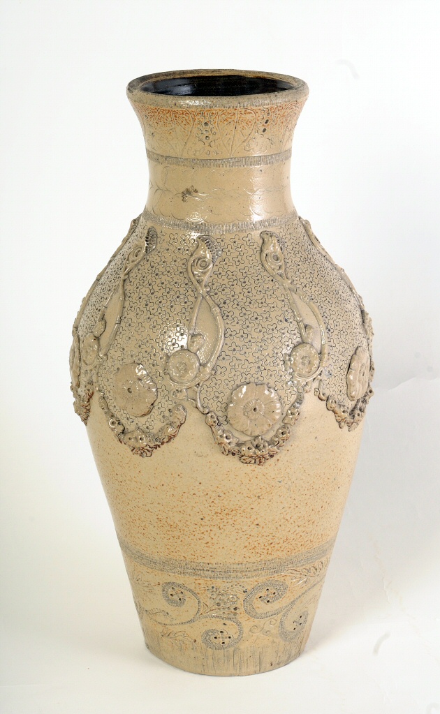 Art pottery vase, stoneware, hatching at top with applied flowers, festoons, and script 's' shapes.