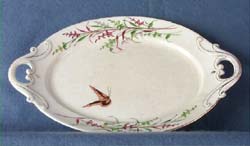 Platter, earthenware, white, red and green floral design at border, butterfly in center, two handles.